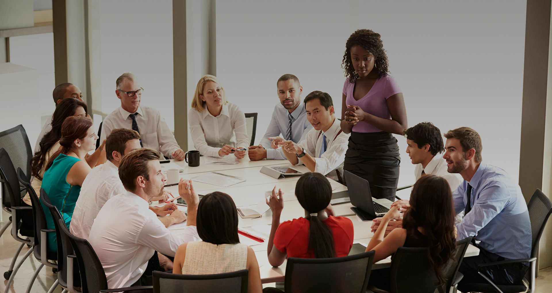 multiple people sitting around a table